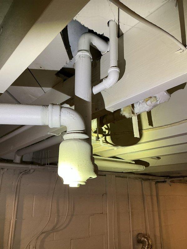 Responded to plumbing leak complaint involving pipes under sink and bathtub. Upon inspection, accessed underside of fixtures through crawlspace/basement area and identified leaking drain lines. Repaired compromised PVC waste pipe connections with new fittings and properly sealed all threaded joints. Replaced deteriorated pipe sections where necessary to ensure watertight system. Verified all connections were secure and tested drainage system to confirm leaks were eliminated. Restored access opening and left work area clean.