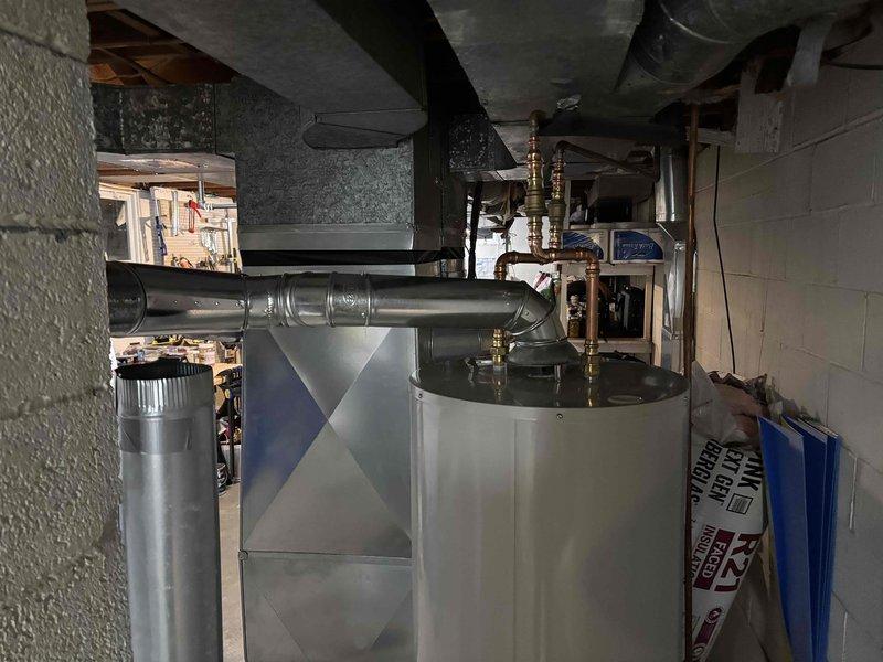 Completed installation of 50-gallon natural gas water heater with 6-year tank and 6-year parts warranty, including water softener installation. Updated chimney Y-connector from 3-inch to 4-inch to meet current venting requirements and ensure proper exhaust flow for the new unit. Provided estimate for additional plumbing work to install drainage for bathroom sink and tub as requested by homeowner.