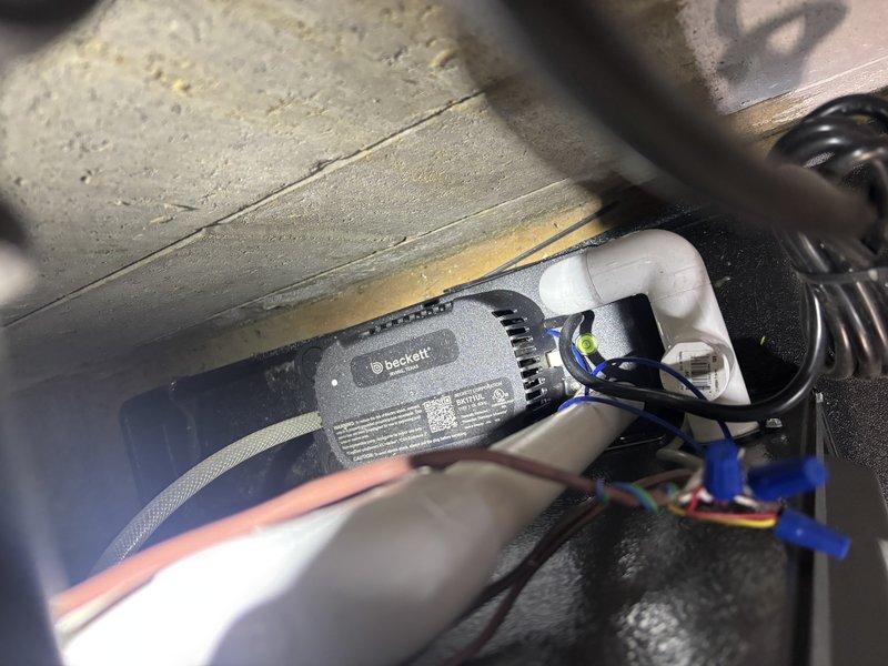 Completed complimentary annual cooling system tune-up on 12-year-old Amana unit. Performed standard maintenance inspection, verified system operation, and documented installation conditions including condensate drain lines and control components with photographic records for service history.
