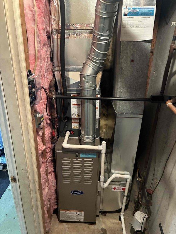 Completed full HVAC system replacement including new Carrier furnace and air conditioning unit. Removed existing equipment and installed new furnace in basement utility area with proper venting configuration using metallic ductwork and PVC condensate drainage lines. Connected all supply and return ductwork to existing distribution system. Installed new AC condenser unit and established refrigerant lines between indoor and outdoor components. Verified all electrical connections, tested system operation across heating and cooling modes, and confirmed proper airflow throughout. System commissioned successfully with all safety controls functioning as designed.