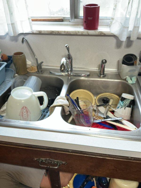 Responded to complaint of reduced hot water flow at kitchen faucet while cold water pressure remained normal. Inspected single-handle chrome faucet assembly at double-basin stainless steel sink. Diagnosed restricted hot water supply line caused by sediment buildup in faucet cartridge. Cleared obstruction and restored proper hot water flow to match cold water pressure.