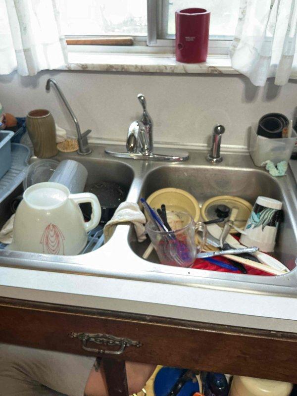 Responded to complaint of reduced hot water flow at kitchen faucet while cold water pressure remained normal. Inspected single-handle chrome faucet assembly at double-basin stainless steel sink. Diagnosed restricted hot water supply line caused by sediment buildup in faucet cartridge. Cleared obstruction and restored proper hot water flow to match cold water pressure.