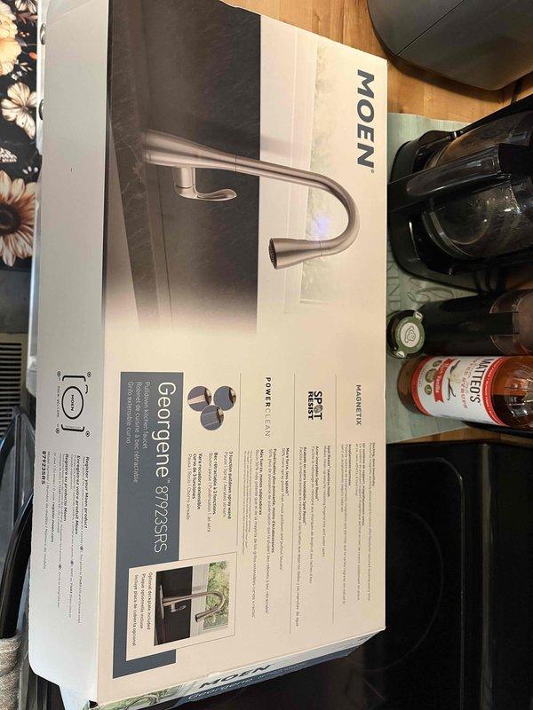 Responded to kitchen faucet replacement request due to water leak under sink. Successfully removed existing faucet and installed new Moen Georgene model 87925RS in brushed nickel finish. Inspected under-sink plumbing connections, garbage disposal unit, and PVC drainage system to ensure proper operation and no additional leaks. All connections secured and tested for functionality.