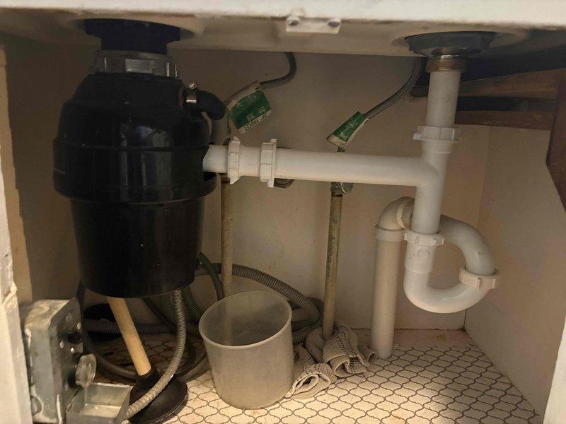 Responded to kitchen faucet replacement request due to water leak under sink. Successfully removed existing faucet and installed new Moen Georgene model 87925RS in brushed nickel finish. Inspected under-sink plumbing connections, garbage disposal unit, and PVC drainage system to ensure proper operation and no additional leaks. All connections secured and tested for functionality.