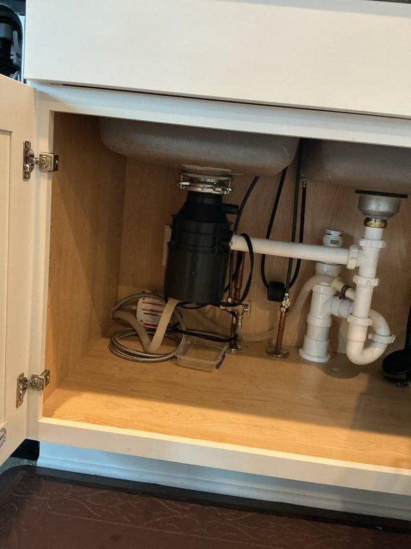 Responded to service call for leaking garbage disposal unit. Upon inspection, identified active leak at disposal mounting assembly beneath kitchen sink. Removed and reinstalled disposal unit with new mounting flange and gasket to eliminate leak. Tested unit operation and verified all connections were secure and leak-free upon completion.