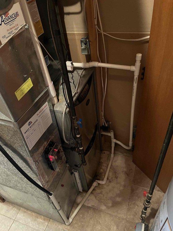 Successfully completed full air conditioning system replacement in residential utility space. Installed new furnace unit with proper ductwork connections, including metallic supply plenum and flexible black ribbed return ductwork. Configured all refrigerant line sets, electrical connections, and condensate drain lines per manufacturer specifications. Verified all safety labels and warning stickers are visible and properly affixed to equipment. System tested and operational upon completion.