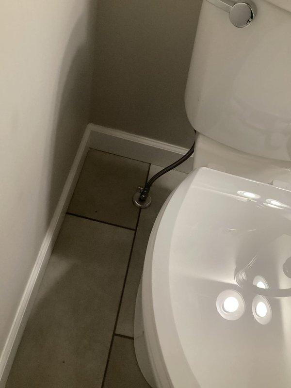 Completed full toilet replacement in residential bathroom. Removed existing toilet, installed new two-piece white porcelain toilet with chrome flush mechanism, connected water supply line, tested for proper operation and leaks, and confirmed all components functioning correctly upon completion.