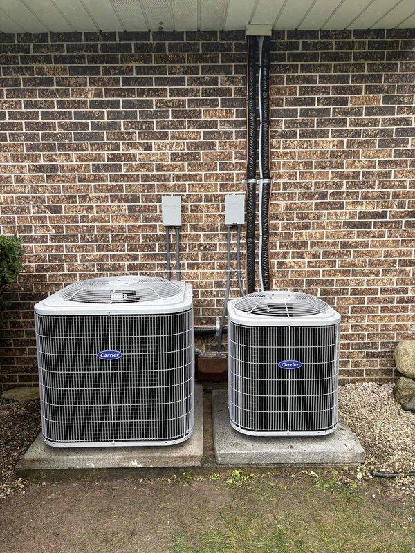 Completed full replacement and installation of two Unico Systems air conditioning units with corresponding air handlers. Installed dual Carrier outdoor condensing units on concrete pads with proper refrigerant line connections, electrical wiring, and conduit routing along exterior wall. Verified system pressures, tested all connections for leaks, confirmed proper operation of both systems, and documented equipment specifications including refrigerant charge levels.