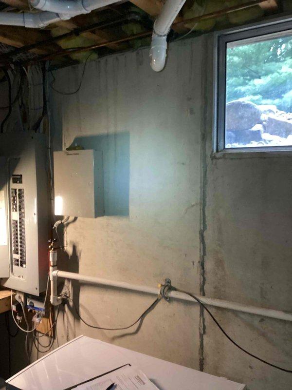 Conducted on-site evaluation for residential backup generator installation at single-family home. Assessed existing electrical infrastructure, including main service panel located in basement utility area with adequate breaker capacity and accessible wiring pathways. Documented electrical panel configuration, available space for transfer switch installation, and routing options for generator connection conduit. Evaluated exterior placement options considering utility access, setback requirements, and fuel line routing from potential natural gas or propane connection points. Photographed current electrical system layout and basement infrastructure to support equipment sizing recommendations and installation planning.
