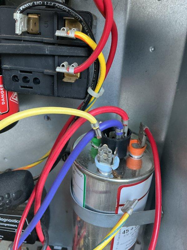 Completed annual cooling maintenance on two air conditioning systems (1-year and 11-year units). Performed comprehensive tune-up procedures including inspection of electrical components, contactors, and capacitors. Verified proper wire connections on contactor terminals and capacitor assembly. Cleaned exterior ventilation grilles which showed significant dust and debris accumulation. Checked system operation and confirmed both units functioning properly. Documented equipment condition with photos showing normal operational wear on internal components.