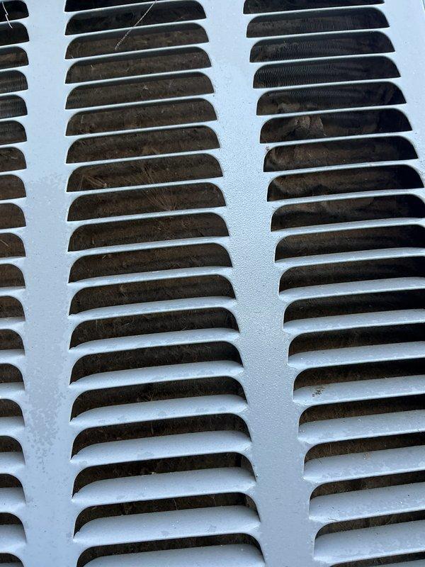 Completed annual cooling maintenance on two air conditioning systems (1-year and 11-year units). Performed comprehensive tune-up procedures including inspection of electrical components, contactors, and capacitors. Verified proper wire connections on contactor terminals and capacitor assembly. Cleaned exterior ventilation grilles which showed significant dust and debris accumulation. Checked system operation and confirmed both units functioning properly. Documented equipment condition with photos showing normal operational wear on internal components.