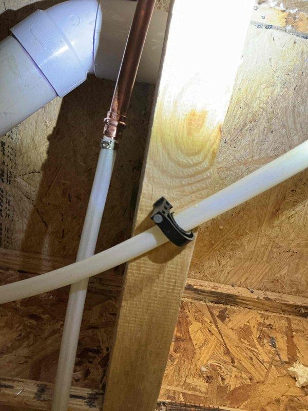 Responded to a non-functional exterior hose bib where the valve handle would turn but no water was dispensed. Successfully replaced the defective hose bib assembly with a new frost-free sillcock, accessing the connection point through the attic space where copper supply lines transition to the exterior fixture. The new installation was properly secured to the exterior wall within the existing recessed mounting box and all connections were tested to ensure proper water flow and operation.