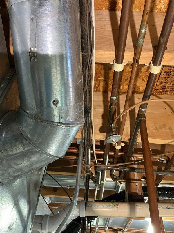 Completed annual heating maintenance visit including furnace tune-up and humidifier inspection. System was found to be operating within manufacturer specifications. Performed standard maintenance procedures, documented equipment condition with photos showing water heater, copper plumbing lines, and HVAC ductwork in mechanical space, and confirmed all components are functioning properly for the heating season.