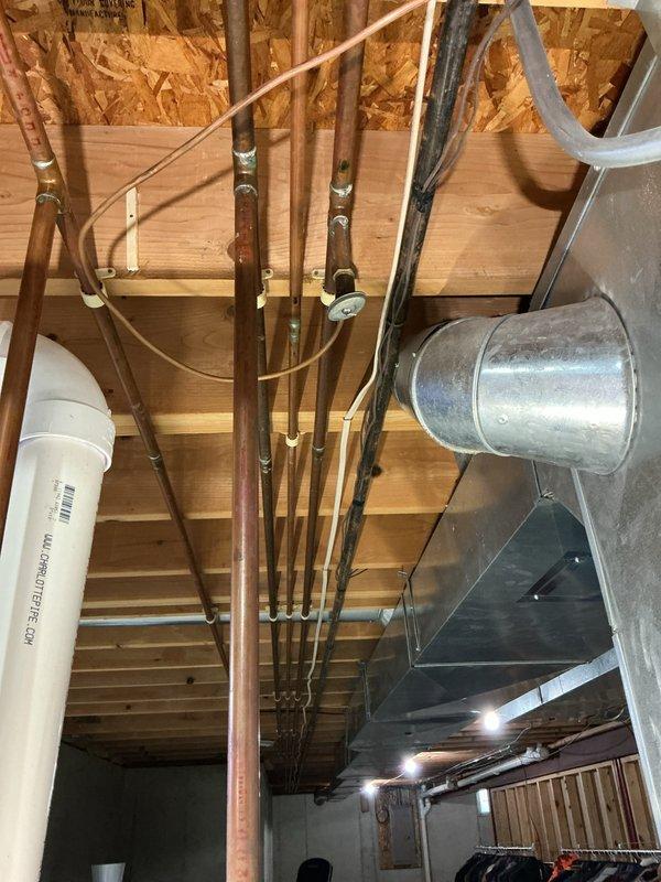 Completed annual heating maintenance visit including furnace tune-up and humidifier inspection. System was found to be operating within manufacturer specifications. Performed standard maintenance procedures, documented equipment condition with photos showing water heater, copper plumbing lines, and HVAC ductwork in mechanical space, and confirmed all components are functioning properly for the heating season.