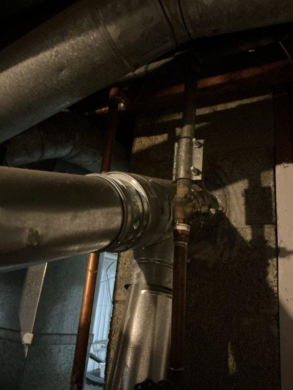Completed full water heater installation in basement utility area. Installed new water heater unit with proper copper supply line connections, drainage configuration, and venting system integration with existing HVAC ductwork. All plumbing connections secured with appropriate fittings and shut-off valves, system tested and verified operational.
