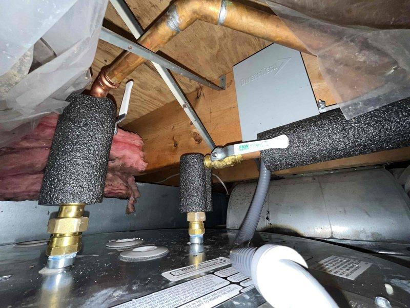 Successfully installed a 47-gallon Bradford White electric water heater (Model RE250LN6-1NCWW) in the attic space. The lowboy unit features dual 4500-watt heating elements operating at 240V single-phase and was properly connected to existing plumbing lines with foam-insulated supply pipes and brass fittings. All electrical connections were completed to manufacturer specifications, and the installation was verified to meet AHRI and UL certification standards.