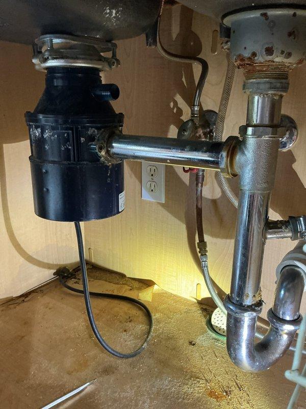Removed and replaced failed garbage disposal unit under kitchen sink. Installed new disposal with proper mounting assembly, connected discharge tube to existing drain system, and verified electrical connection. Tested unit for proper operation and drainage flow with no leaks detected.