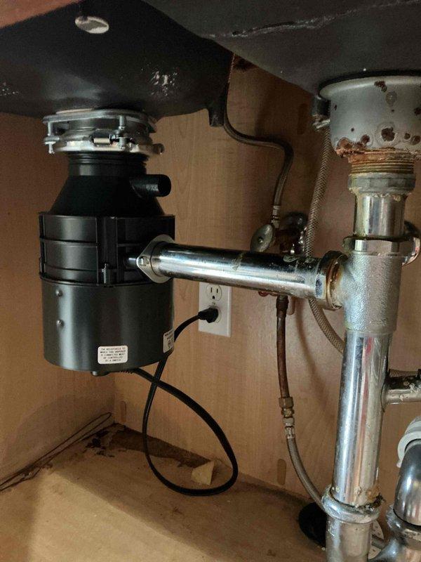 Removed and replaced failed garbage disposal unit under kitchen sink. Installed new disposal with proper mounting assembly, connected discharge tube to existing drain system, and verified electrical connection. Tested unit for proper operation and drainage flow with no leaks detected.
