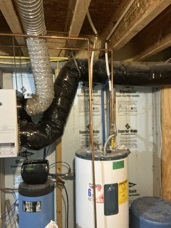 Completed furnace and air conditioning replacement estimate for property currently equipped with a 16-year-old geothermal Water Furnace system that is no longer operational. Client reported inadequate water flow to the geothermal system affecting cooling performance, though well pump has been verified as functioning properly and another contractor indicated refrigerant levels are adequate. Assessed existing vertical HVAC unit installation in unfinished basement with metallic ductwork and evaluated mechanical room containing water heater and water treatment equipment. Provided comprehensive estimate for converting from geothermal heating and cooling system to conventional furnace and air conditioning equipment.