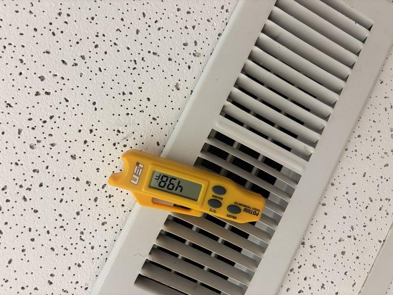 Responded to cooling complaint where AC unit was not reaching set temperature. Performed diagnostic testing at supply registers using digital measurement equipment, recording temperature differentials of -26°F and -86.4°F across multiple vents to assess system performance and airflow distribution. Based on measurements taken, system was evaluated for proper cooling capacity and thermostat calibration issues were addressed to restore unit to normal operation.