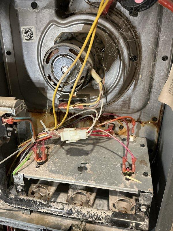 # No Heat Service Call

Responded to no heat condition on HVAC system. Upon arrival, found thermostat set to 71°F but unit not operating. Removed access panel and performed thorough inspection of furnace interior. Discovered blower motor assembly and electrical connections heavily contaminated with dust, debris, and biological growth. Multiple wire terminals showed signs of oxidation and corrosion affecting electrical continuity. Lower burner compartment exhibited significant accumulation of dirt and particulate matter restricting airflow and preventing proper ignition sequence.

Cleaned all electrical connections and terminals, removing corrosion from mounting plate and wire connectors. Vacuumed and cleaned blower motor housing and lower burner assembly, removing heavy debris buildup. Verified all wire connections were secure and making proper contact. Tested unit operation and confirmed ignition sequence completed successfully. System now heating properly with thermostat maintaining 