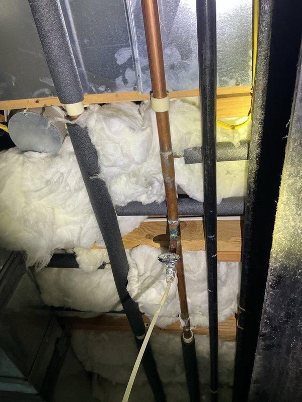 Responded to water leak service call for pinhole leak on copper water line supplying ice maker. Located leak in attic space on vertical copper supply line running through insulated wall cavity. Repaired damaged section of copper piping and verified system integrity. Tested water flow to ice maker connection and confirmed no additional leaks present after repair completion.