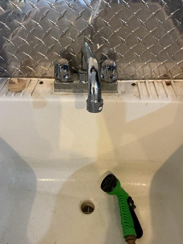 Responded to multiple plumbing concerns throughout the residence. Addressed kitchen sink leak where disposal connection had become disconnected, causing water to back up into the opposite basin. Inspected and repaired leak at utility sink in garage. Investigated lack of hot water supply at garage sink following recent water heater replacement and restored proper hot water flow. Performed integrity assessment of sump pump system to evaluate remaining service life and operational reliability. Diagnosed drainage issue where dishwasher discharge was creating back-pressure in the plumbing system, affecting upstairs bathroom toilet flush performance, indicating potential venting or drain line restriction requiring further evaluation.