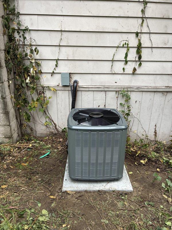 Completed full HVAC system installation including new forced-air furnace and outdoor condensing unit. Installed furnace in basement utility area with proper ductwork connections and PVC venting. Mounted outdoor AC condenser on concrete pad against building exterior with electrical conduit and junction box connection to structure. Verified all refrigerant lines, electrical connections, and drainage systems properly installed and operational. System tested and confirmed functioning within manufacturer specifications.