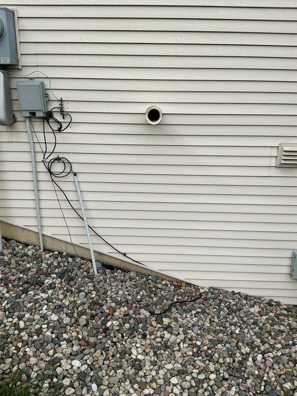 Responded to service call for malfunctioning 11-year-old Bradford White standard tank water heater installed in 2014. Conducted on-site assessment and documented existing equipment configuration, including exterior venting system with PVC penetration through building siding and mechanical components. Provided estimate for water heater replacement options based on current system age and condition.