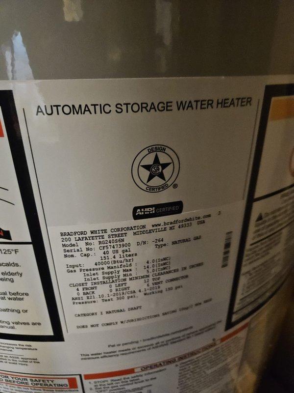 Completed installation of Bradford White 40-gallon automatic storage water heater, model BUC240S6N, with 40,000 BTU/h input capacity in residential utility room. Unit was properly positioned, all supply and discharge piping connections were secured, exhaust venting was installed to manufacturer specifications, and gas line connections were completed and pressure-tested for safe operation. Water heater was installed adjacent to existing furnace system within exposed framing area, with all work meeting ANSI Z21 certification standards and local code requirements for proper clearances and ventilation.