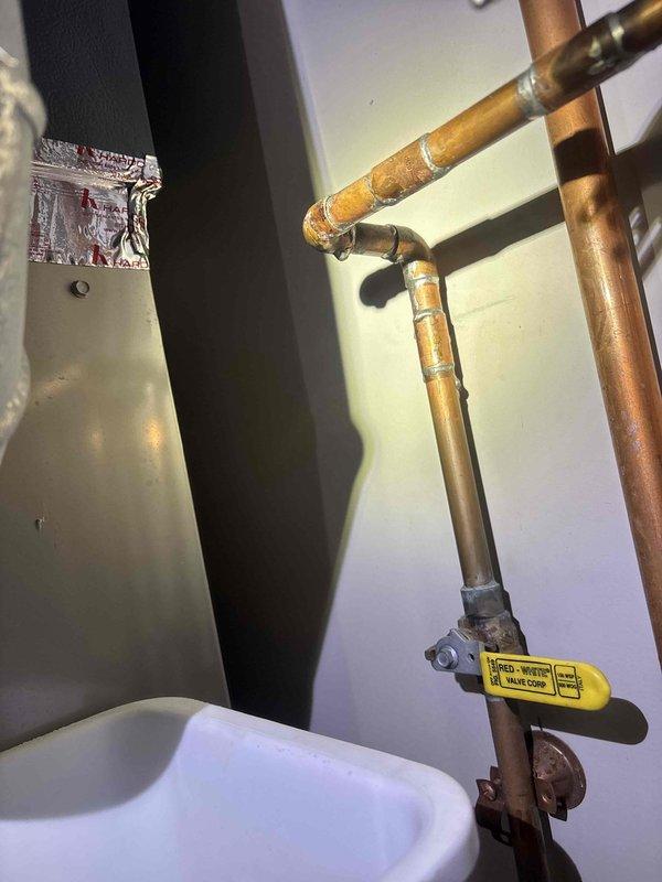 Responded to a water leak emergency in the mechanical room affecting the furnace. Identified and repaired a leaking elbow fitting on the recirculating line between the water heater and furnace that was actively spraying water onto the furnace equipment. Additionally, replaced a faulty shut-off valve on the humidifier water feed line that was also leaking. Both repairs completed to restore proper operation and prevent water damage to HVAC equipment.