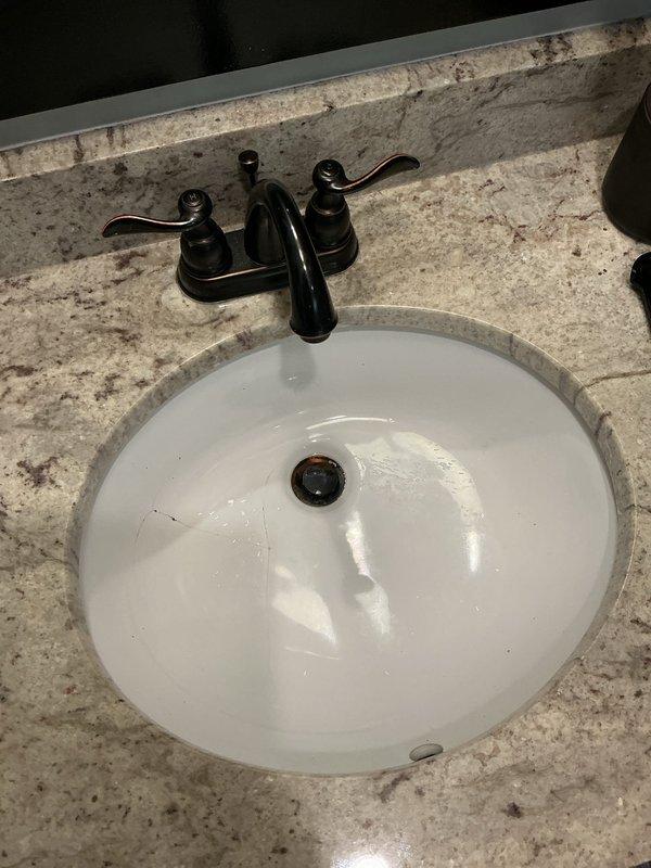 Completed undermount bathroom sink and faucet installation in two bathrooms. Installed oval white porcelain undermount sinks into granite countertops and mounted new black oil-rubbed bronze faucets with dual lever handles. Ensured proper mounting, sealing, and connection of all plumbing fixtures with verification of drainage functionality and no leaks detected upon completion.