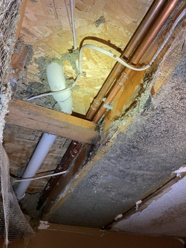 Completed leak removal and repair of 3/4" and 1/2" copper piping in attic crawl space. Addressed water intrusion damage evident on structural surfaces and replaced compromised copper lines. Applied proper sealing around pipe penetrations through OSB flooring and secured all refrigerant lines with appropriate fasteners.