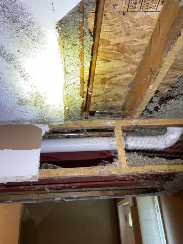 Completed leak removal and repair of 3/4" and 1/2" copper piping in attic crawl space. Addressed water intrusion damage evident on structural surfaces and replaced compromised copper lines. Applied proper sealing around pipe penetrations through OSB flooring and secured all refrigerant lines with appropriate fasteners.