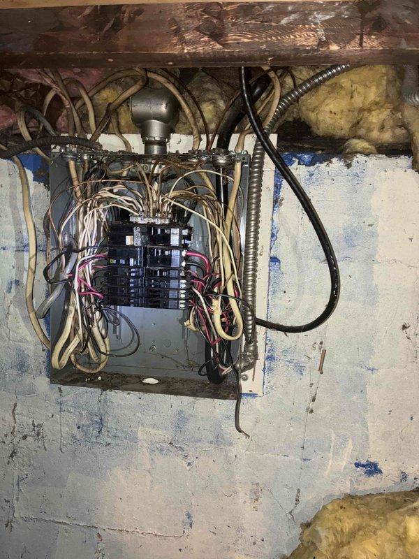 Conducted comprehensive furnace and air conditioning system estimate for residential property with aging HVAC equipment. Evaluated existing 16-year-old furnace requiring replacement and assessed feasibility of adding central air conditioning system. Performed thorough inspection of electrical infrastructure, documenting existing breaker panel condition, wiring configuration, and electrical capacity to determine compatibility with new high-efficiency heating and cooling equipment. Photographed electrical panel showing outdated wiring arrangement, disorganized conductor routing, and potential code compliance concerns that would need addressing during HVAC system installation. Assessed basement utility area structural conditions, including exposed floor joists, existing insulation, and available space for equipment placement. Provided recommendations for complete HVAC system replacement including appropriately-sized furnace and air conditioner units, along with necessary electrical panel 