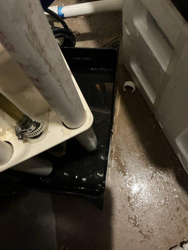 Completed annual heating and cooling maintenance on 5-year-old EnergiAir unit and 8-year-old Trane furnace. Inspected condensate drain system and documented active drainage with visible water staining in drain pan and moisture accumulation in mechanical space beneath equipment. Condensate pump operating and draining properly through connected tubing with secure fittings observed.