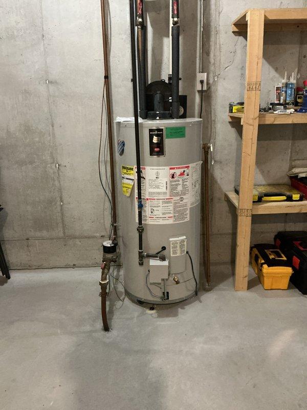 Conducted on-site evaluation for replacement of existing 50-gallon Bradford White residential water heater located in basement utility area. Assessed current installation including plumbing connections, electrical supply, venting configuration, and clearance requirements. Documented existing unit specifications, pipe configurations with copper supply lines and shutoff valves, and surrounding workspace conditions to provide accurate replacement estimate.
