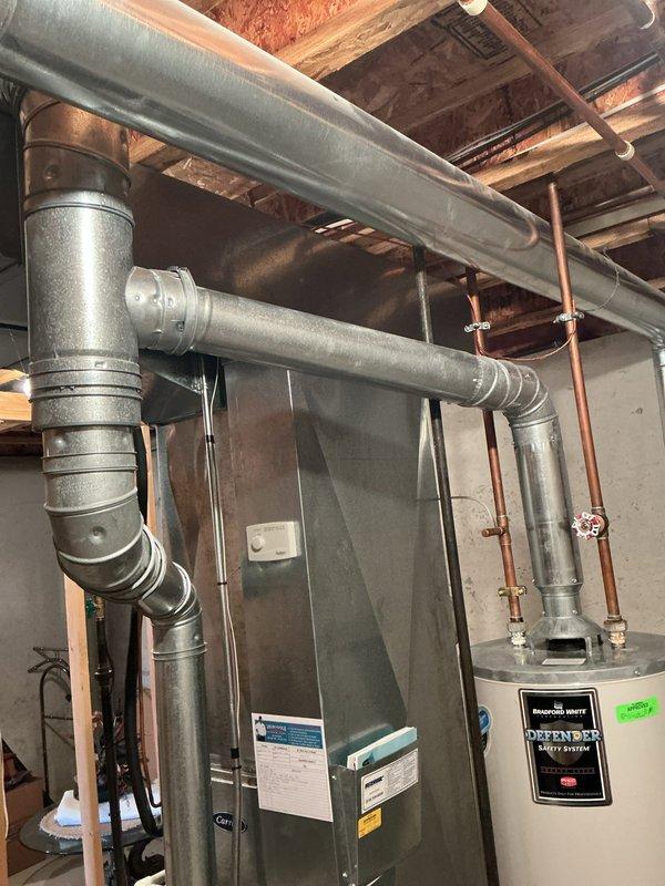 Completed comprehensive furnace super tune-up on 22-year-old Carrier unit located in basement utility room. Performed full system inspection including burner assembly cleaning, heat exchanger examination, blower motor lubrication, air filter replacement, thermostat calibration, and combustion analysis to ensure safe and efficient operation. Also provided water heater estimate for Bradford White Defender Safety System unit as time permitted during the service visit.