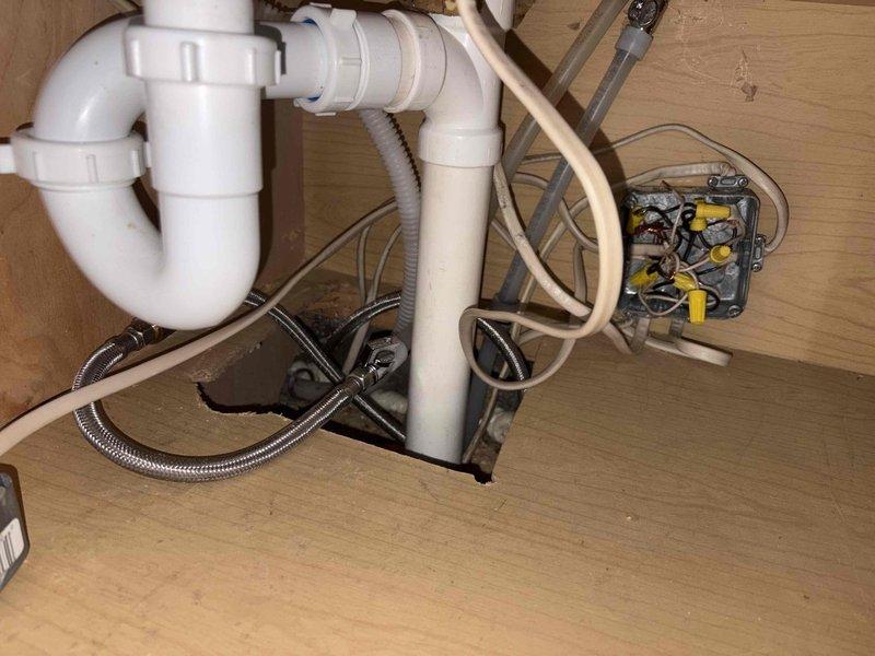 Responded to emergency call for active water leak at residential property. Upon arrival and inspection, located source of leak at kitchen sink P-trap assembly beneath cabinet. Found loose slip-joint connection on PVC P-trap allowing water to escape during sink usage. Tightened slip-joint fittings on P-trap assembly to manufacturer specifications and tested system by running water through sink drain. Verified no additional leaks present and confirmed all plumbing connections secure and functioning properly.