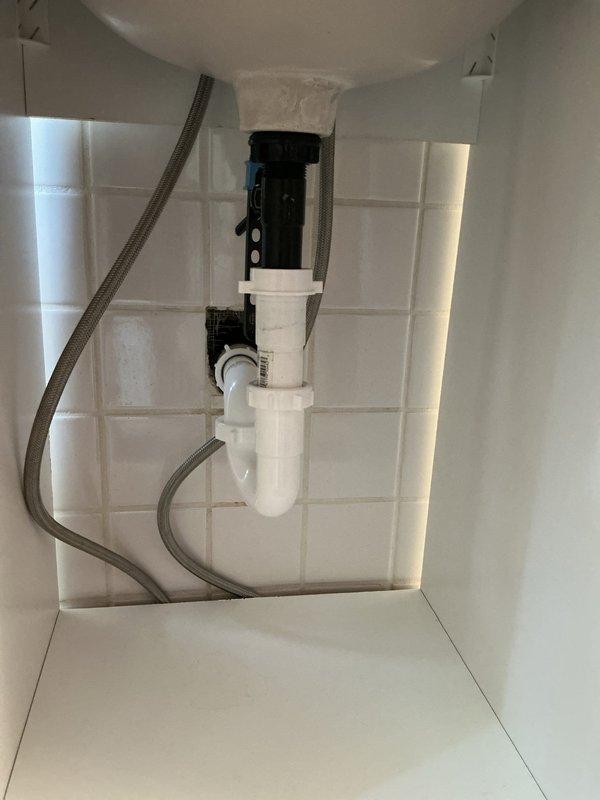 Responded to rental inspection violations by replacing the leaking temperature/pressure relief valve on the water heater, removing corrugated drain material under the second-floor bathroom sink and installing approved PVC drain assembly with proper P-trap configuration, and installing an approved vacuum breaker on the shower hose assembly. All plumbing work completed to code specifications in preparation for municipal re-inspection.