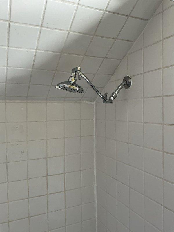 Responded to rental inspection violations by replacing the leaking temperature/pressure relief valve on the water heater, removing corrugated drain material under the second-floor bathroom sink and installing approved PVC drain assembly with proper P-trap configuration, and installing an approved vacuum breaker on the shower hose assembly. All plumbing work completed to code specifications in preparation for municipal re-inspection.