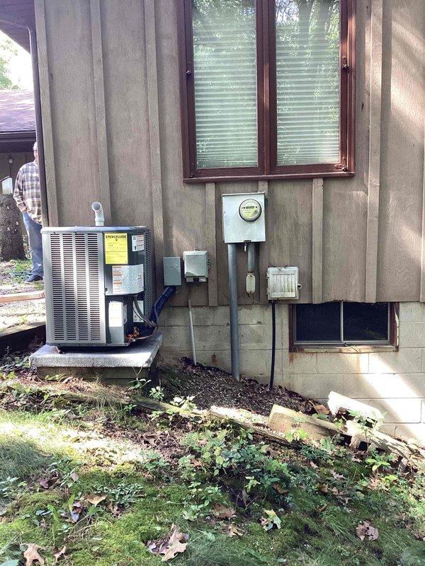 Completed generator estimate for residential property with two EnergiAir WT 11-2035 units currently installed. Evaluated exterior HVAC condenser unit mounted on concrete pad with associated electrical components including meter socket, conduit, junction boxes, and disconnect panel. Assessed basement utility room infrastructure with exposed electrical panel, PVC piping, and available space for potential generator installation. Documented existing electrical service configuration and photographed equipment locations to provide comprehensive estimate for standby generator system integration with current HVAC setup.