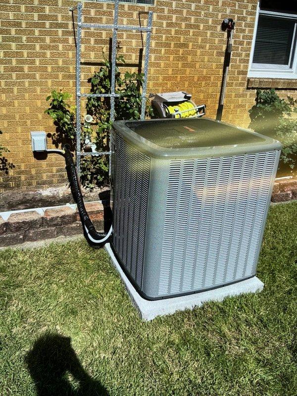Completed full HVAC system installation including new furnace and air conditioning unit. Installed outdoor condensing unit on concrete pad with proper refrigerant line connections and electrical conduit routing along exterior brick wall. Indoor installation included furnace with metal ductwork integration, proper drainage pan placement, and complete system startup and testing to verify operational performance.