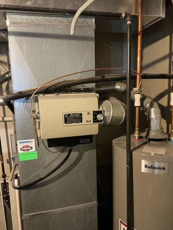 Completed furnace estimate for aging HVAC system with 28-year-old equipment currently operating properly. Documented existing Tempstar furnace installation with auxiliary humidifier unit, ductwork configuration, and associated mechanical components to provide replacement options for customer consideration.