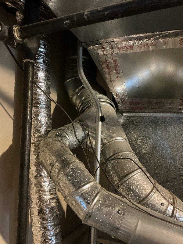 Completed furnace estimate for aging HVAC system with 28-year-old equipment currently operating properly. Documented existing Tempstar furnace installation with auxiliary humidifier unit, ductwork configuration, and associated mechanical components to provide replacement options for customer consideration.