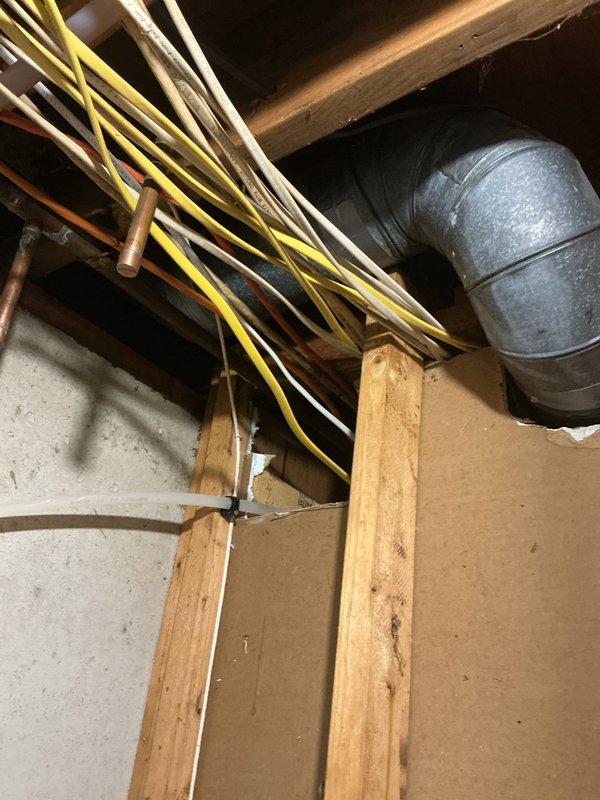 Performed electrical assessment for bathroom lighting and GFCI outlet installation above shower and vanity areas. Evaluated existing electrical infrastructure in basement ceiling space, documenting routing of current electrical cables, conduit paths, and available access points through floor joists for new circuit installation. Assessed exterior electrical service panel and meter location to determine capacity and feasibility for potential future generator connection. Photographed utility routing, structural framing, and service equipment to provide comprehensive documentation for proposed electrical upgrades.