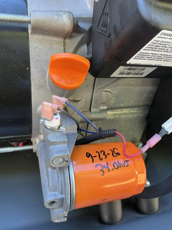 Completed annual generator tune-up and preventive maintenance inspection. Verified all electrical connections including wire terminals with heat-shrink connectors and pin-style connectors on ignition components. Inspected engine block assembly, mounting hardware, and associated mechanical components for proper torque and condition. Documented component markings and resistance values on ignition system. Examined fuel system including piping, insulated lines, and valve assemblies with orange-handled shutoff valves. Verified specification label information and equipment ratings. Photographed key components for service records. All systems operating within normal parameters upon completion of routine maintenance.