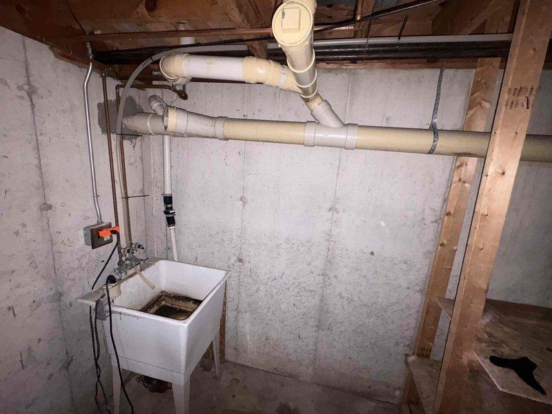 Responded to plumbing service call for low water pressure and continuously running toilet. Upon inspection, assessed water supply system and plumbing infrastructure in basement utility area. Diagnosed toilet fill valve malfunction causing constant water flow. Adjusted fill valve mechanism and verified proper shutoff operation. Tested water pressure throughout system and confirmed adequate flow restoration. Documented existing plumbing configuration and mechanical room conditions with photos for service records.