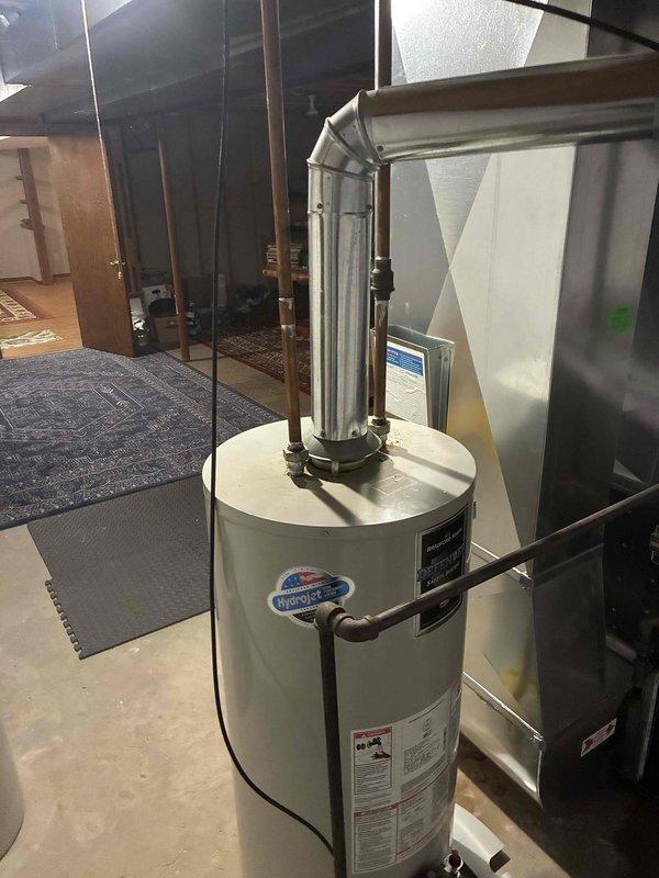 Conducted water heater replacement estimate for 22-year-old Bradford White unit located in end-unit condo basement. Assessed existing installation including venting configuration, utility connections, and clearance requirements in mechanical room shared with HVAC equipment. Documented current water heater condition and provided replacement options for non-emergency scheduling.