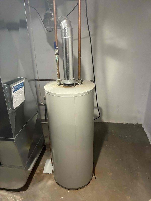 Conducted water heater replacement estimate for 22-year-old Bradford White unit located in end-unit condo basement. Assessed existing installation including venting configuration, utility connections, and clearance requirements in mechanical room shared with HVAC equipment. Documented current water heater condition and provided replacement options for non-emergency scheduling.